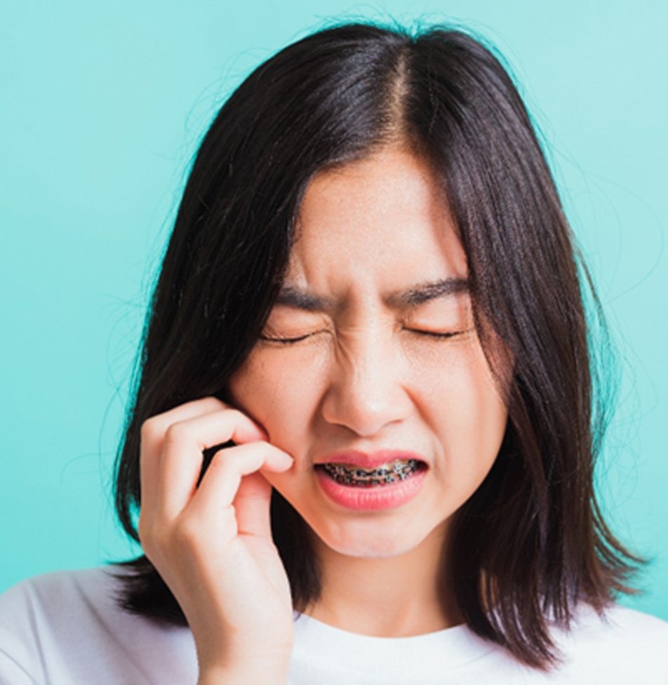 woman with braces in pain