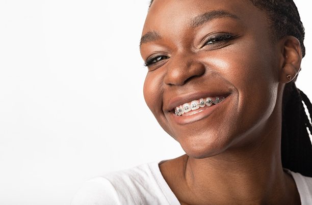 Girl with braces smiling after visiting emergency orthodontist in Southbridge 