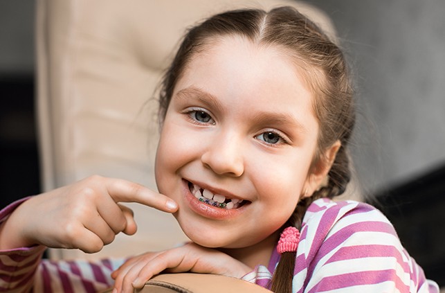 Young girl with pediatric orthodontics smiling