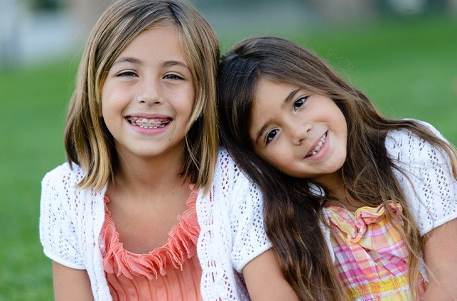 Two young girls receiving dentofacial orthopedic treatment