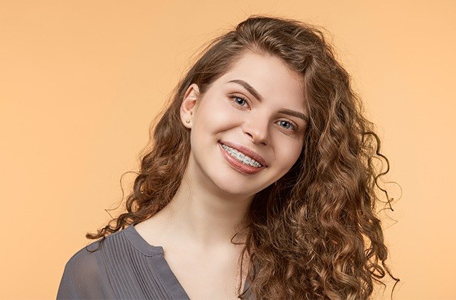 Young woman with traditional braces smiling