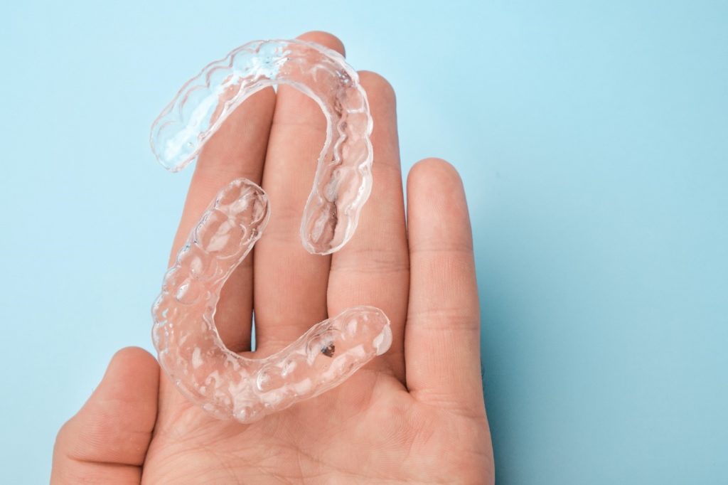 Patient holding clear aligners 