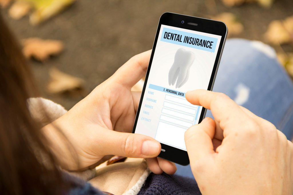 Woman looking at dental insurance information on phone