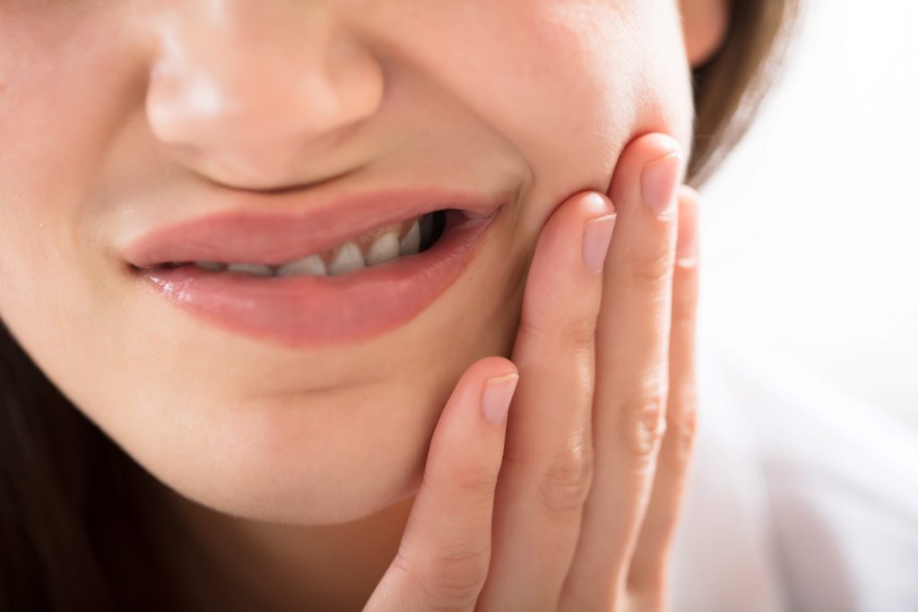 Closeup of woman struggling with gum irritation