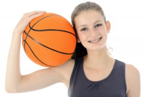 Woman with basketball for sports and orthodontics