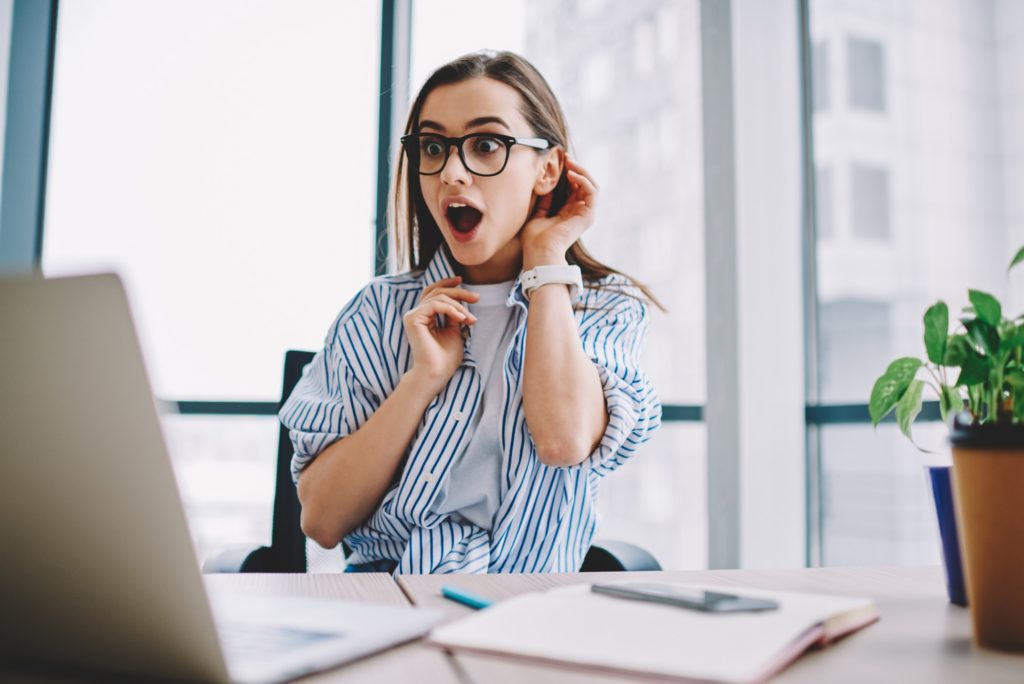 Woman reacting excitedly to tax refund